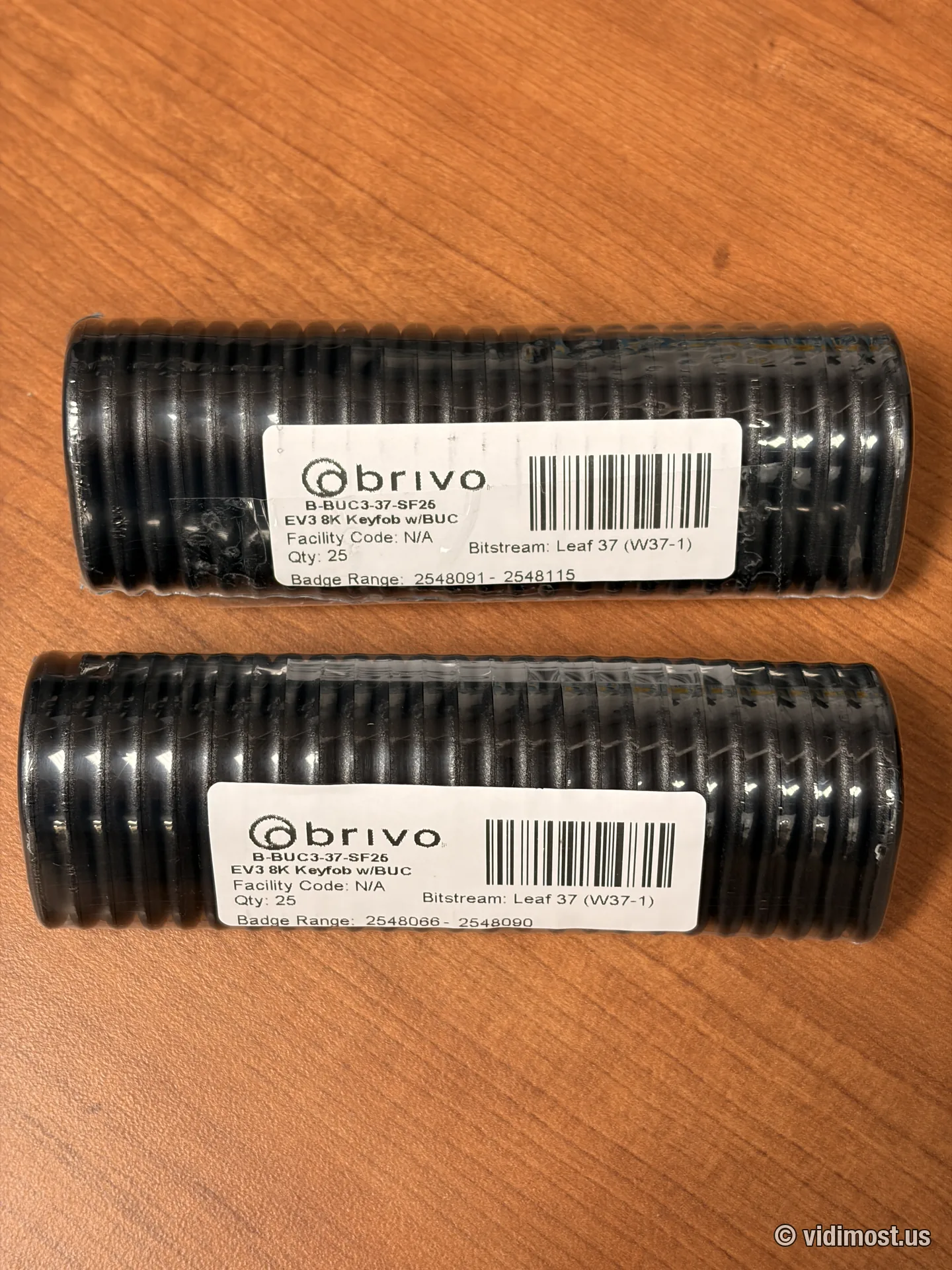 Two factory-sealed tubes of Brivo B-BUC3-37-SF25 keyfobs, 25 fobs each, with printed badge ranges on the labels