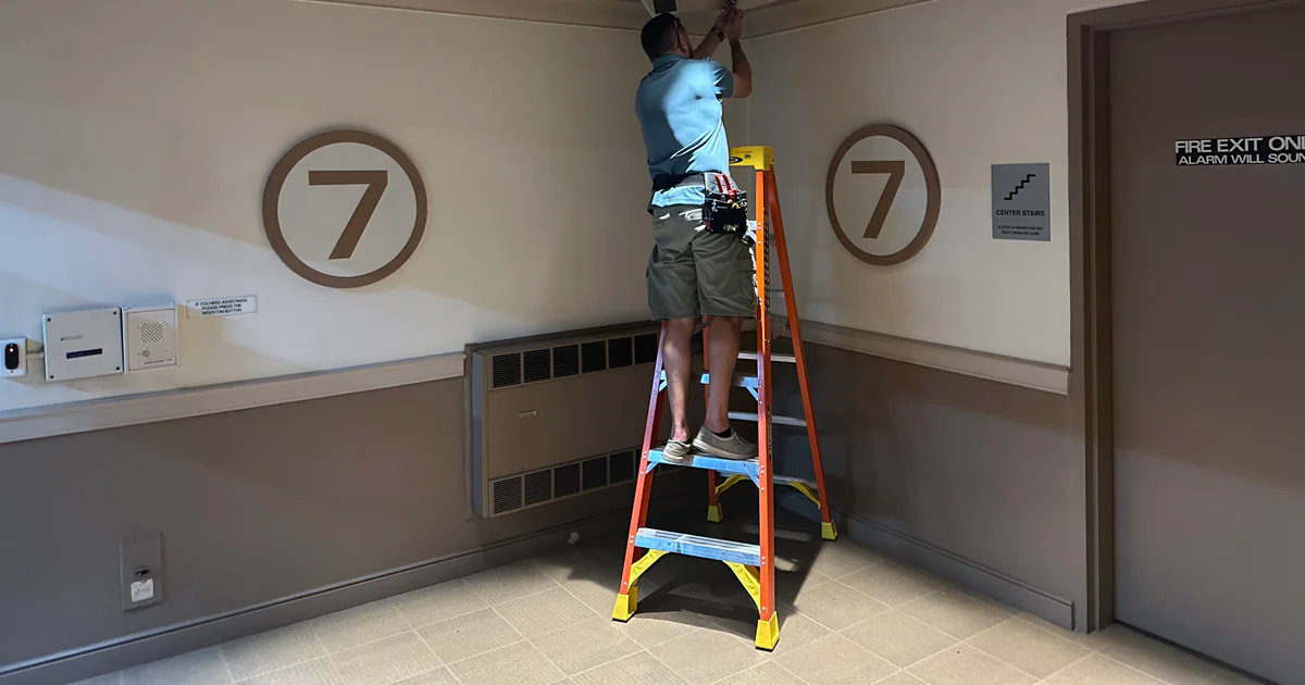 Vidimost technician documenting a Chicago commercial security system rack during a takeover assessment